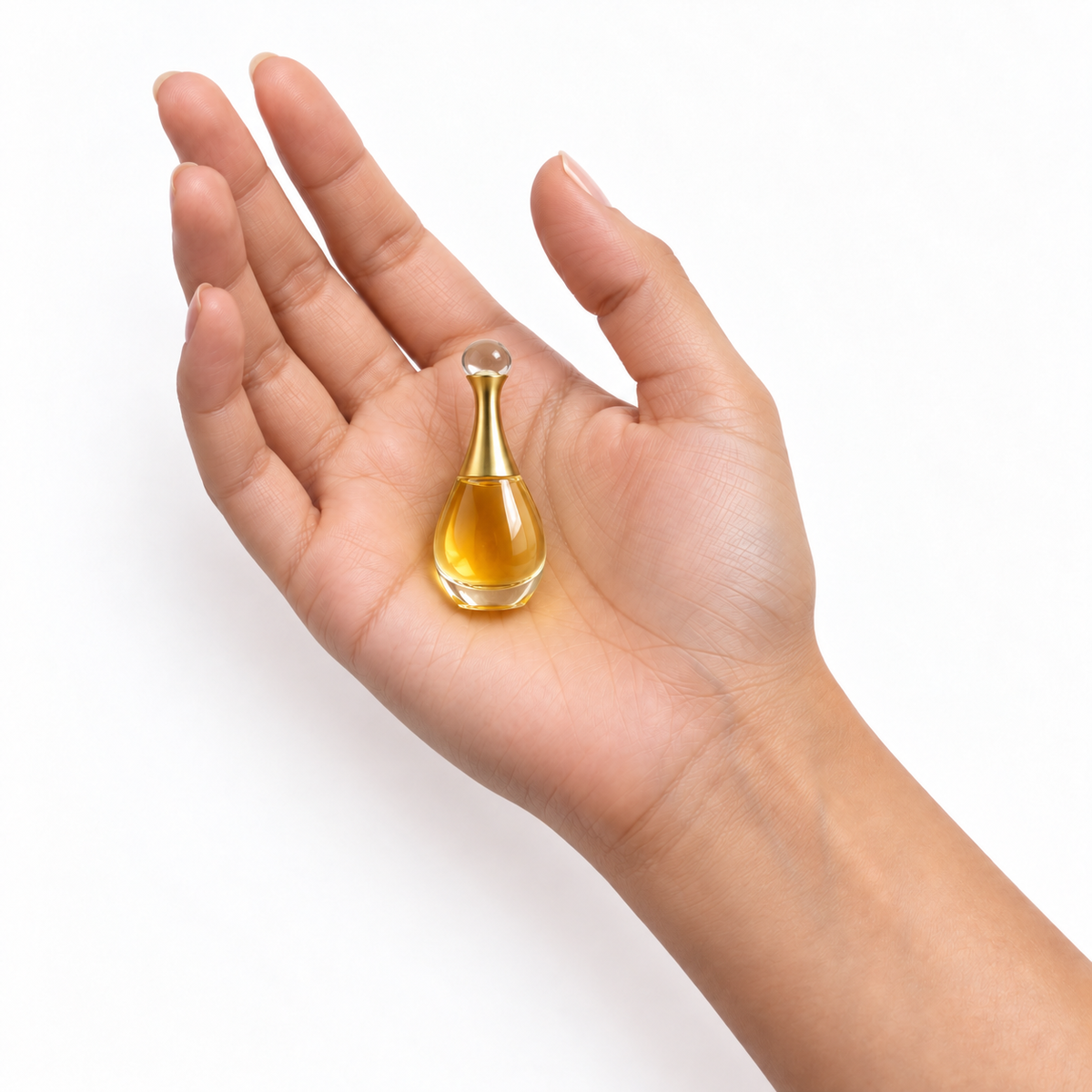 Golden Bouquet 5ml miniature resting in a palm on white
