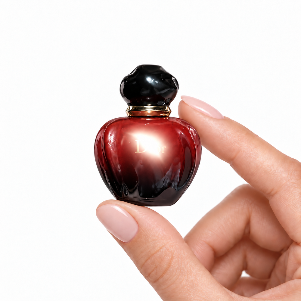 Almond Reverie 5ml miniature held between fingertips on white
