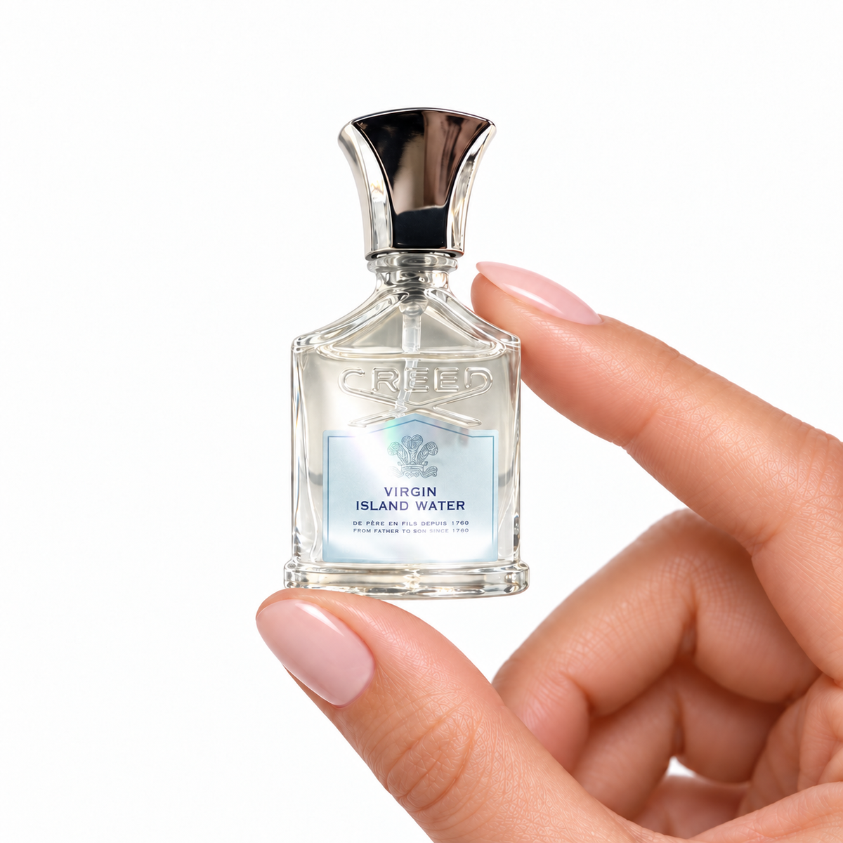 Island Lime miniature fragrance held between fingertips on white