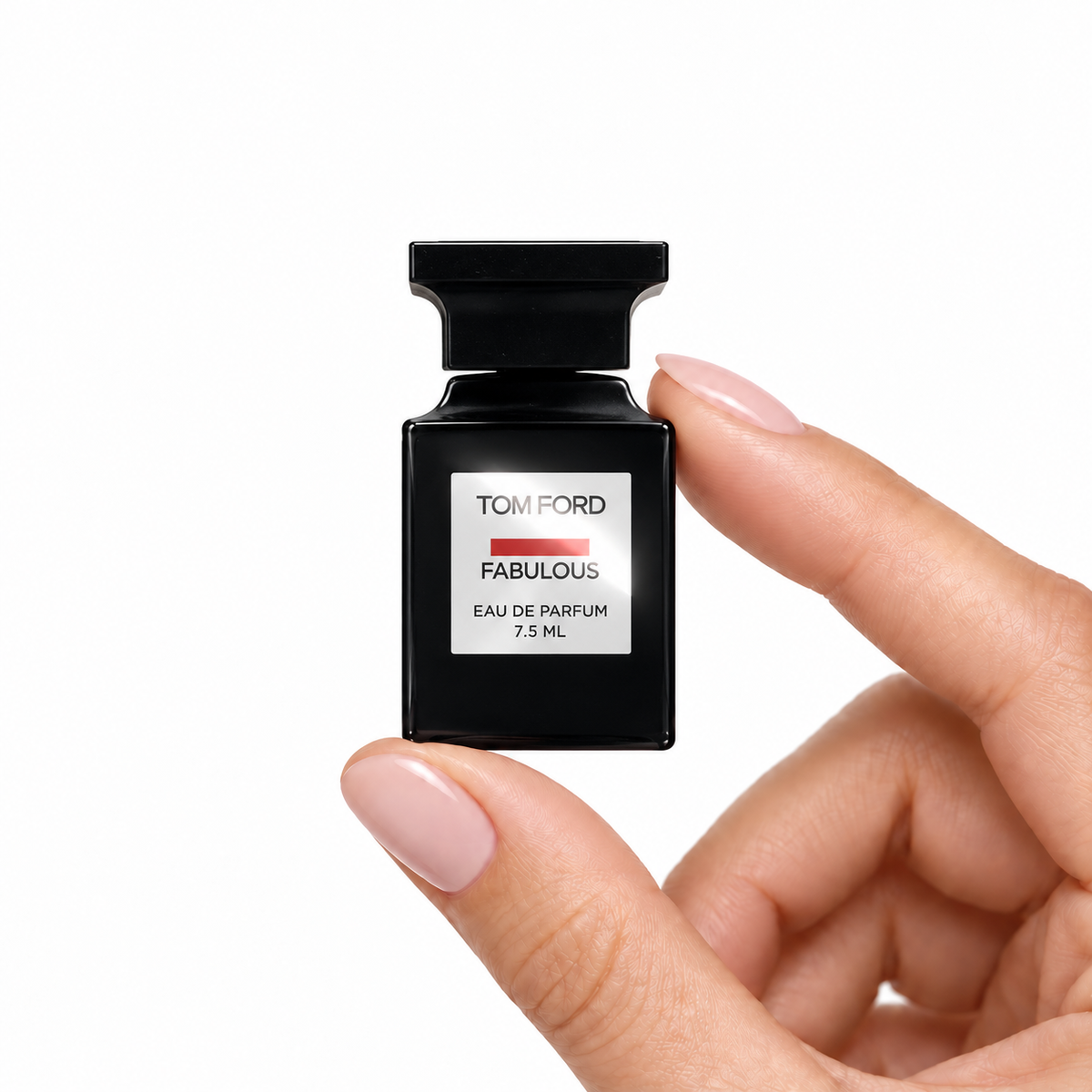 TF · Velvet Afterdark miniature fragrance held between fingertips on white